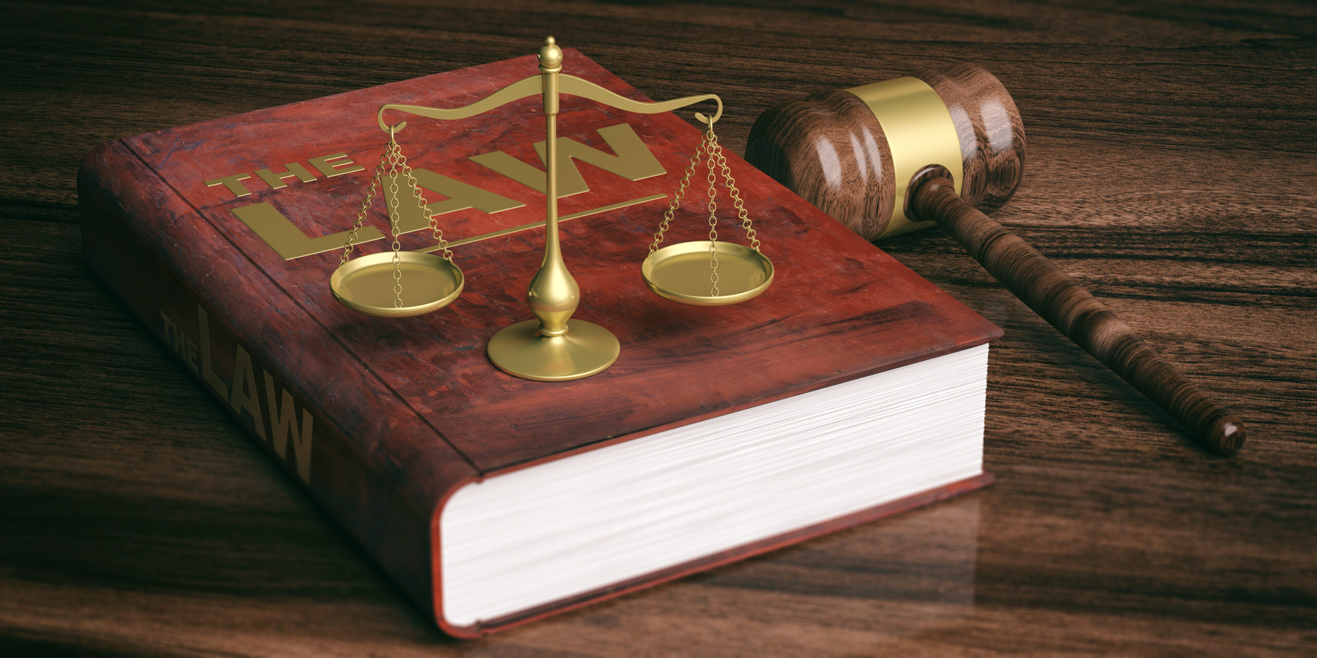 Judge gavel, justice scale, and law book on top of a wooden table, signifying that a money lender has to be licensed